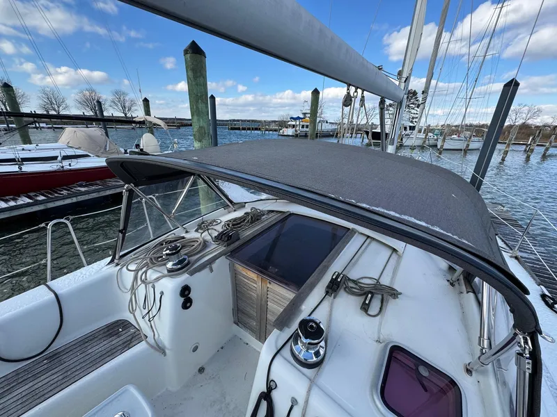 Slide: The Image of 2012 Beneteau 40 sailboat cockpit with canopy, docked at marina under blue sky. - 3