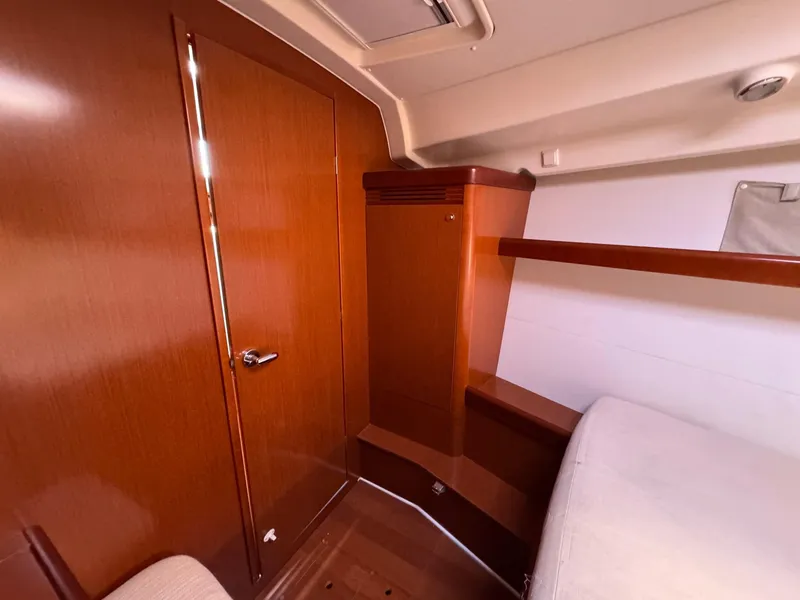 Slide: The Image of Interior cabin of 2012 Beneteau 40 yacht with wooden finish and storage space. - 34