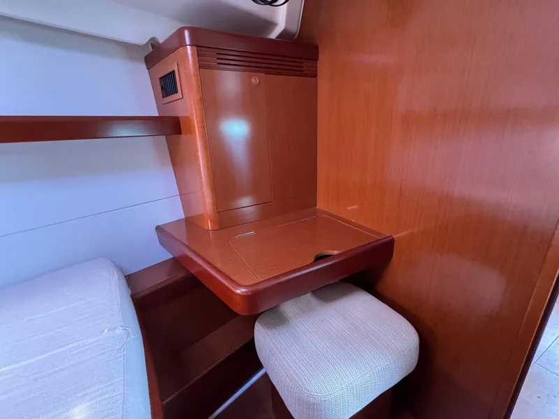 Slide: The Image of Cozy interior of 2012 Beneteau 40 yacht with wooden desk and cushioned stool. - 35