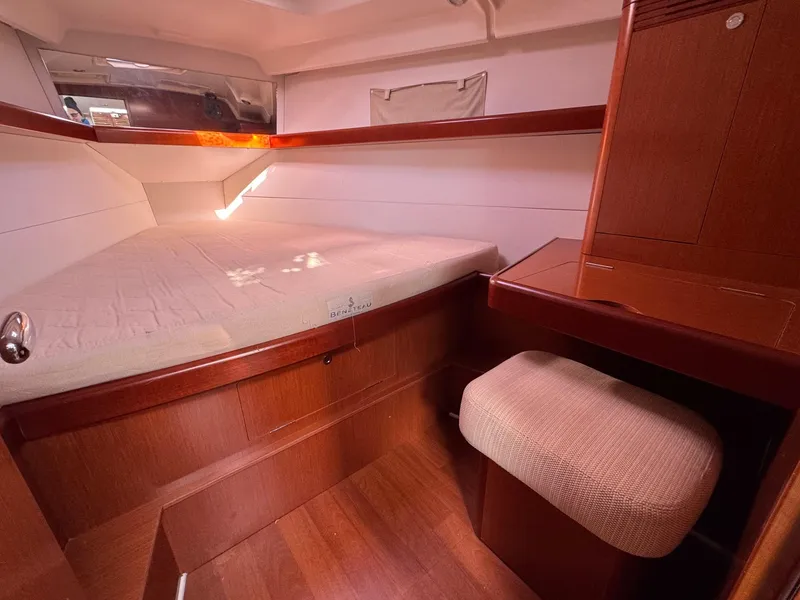 Slide: The Image of Cozy cabin interior of 2012 Beneteau 40 yacht with wooden furnishings and cushioned seating. - 36