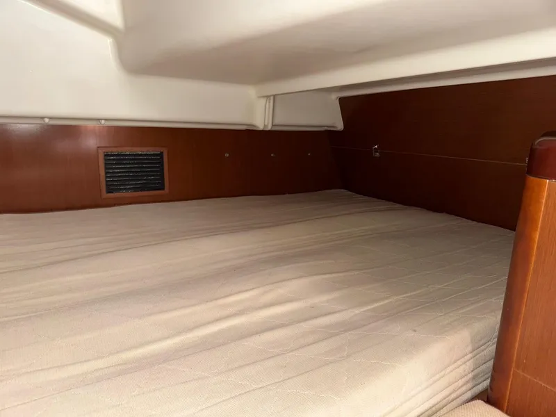 Slide: The Image of Cabin interior of 2012 Beneteau 40 sailboat with wooden finish and beige bedding. - 39