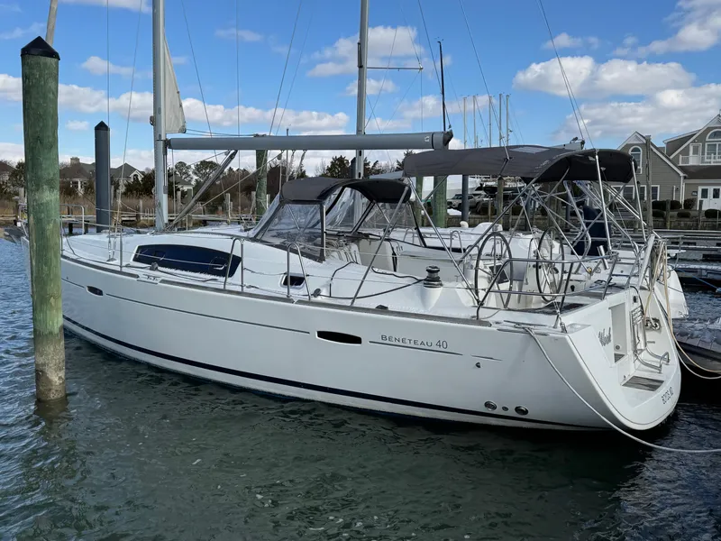 Slide: The Image of 2012 Beneteau 40 sailboat docked in a marina, featuring sleek design and spacious deck. - 5