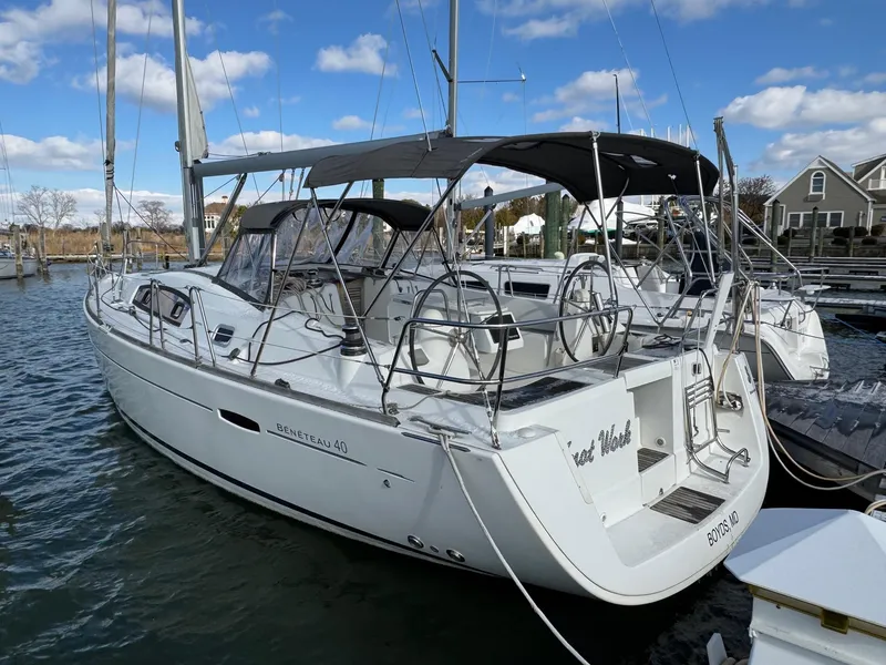 Slide: The Image of 2012 Beneteau 40 sailboat docked in a marina under a clear blue sky. - 6