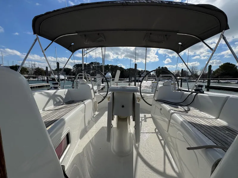 Slide: The Image of Beneteau 40 sailboat cockpit, 2012 model, featuring dual steering wheels and shaded seating area. - 9