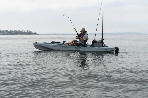 Slide: The Image of Man fishing on 2023 Hobie Passport 12 kayak in calm waters. - 3