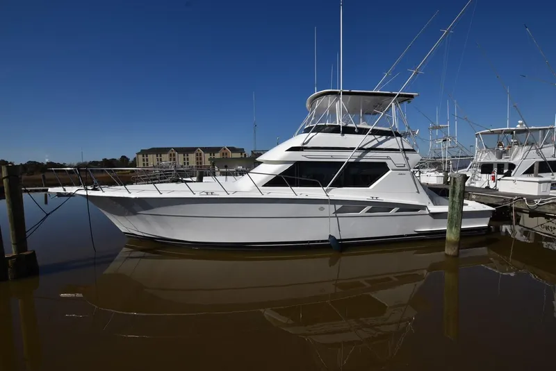 The Image of 1996 Hatteras 50 Convertible yacht docked in marina, side view. - 0