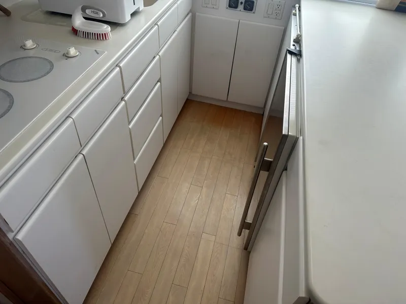 Slide: The Image of Interior of 1996 Hatteras 50 Convertible yacht with modern kitchen and seating area. - 10