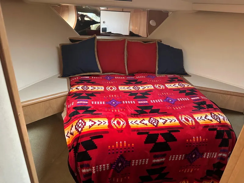 Slide: The Image of Cozy bedroom in 1996 Hatteras 50 Convertible yacht with vibrant bedding and wooden cabinetry. - 17