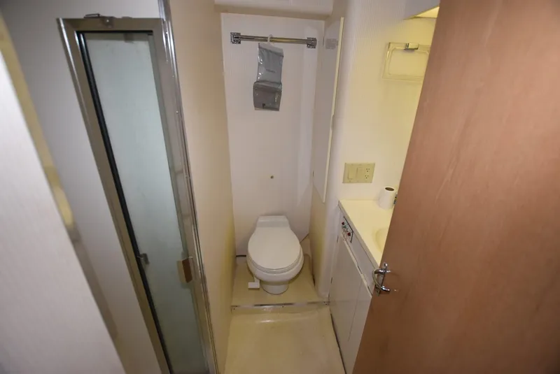 Slide: The Image of Cozy bedroom in 1996 Hatteras 50 Convertible yacht with vibrant patterned bedding. - 18