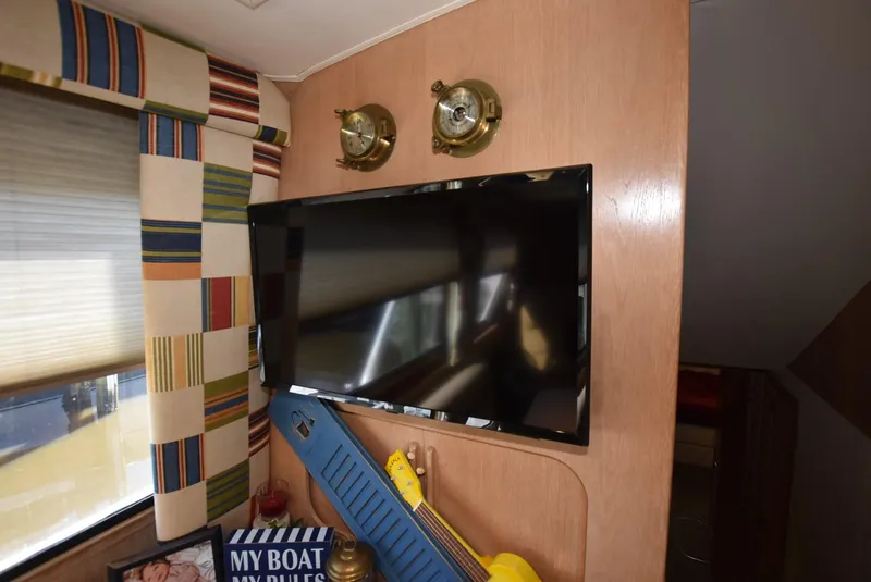 Slide: The Image of Stairway inside 1996 Hatteras 50 Convertible yacht, featuring wooden paneling and narrow passage. - 20