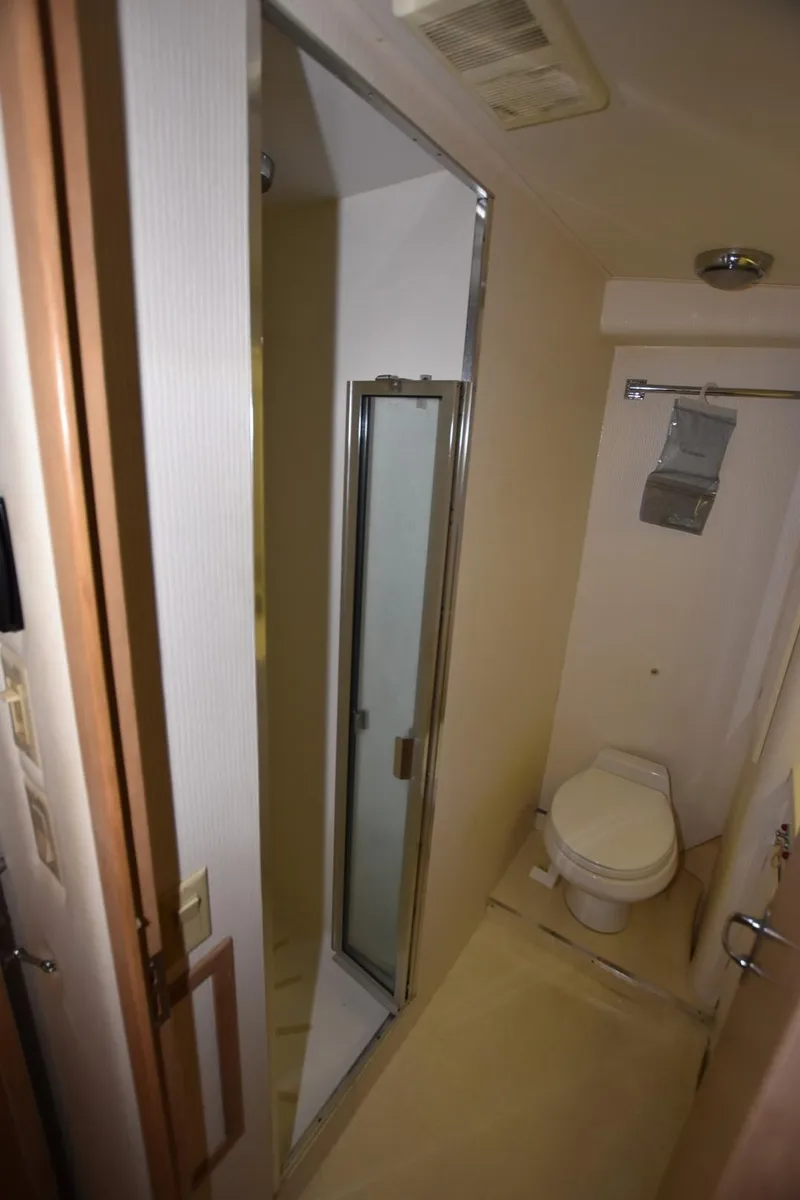 Slide: The Image of Bathroom interior of 1996 Hatteras 50 Convertible yacht, featuring toilet and sink. - 26