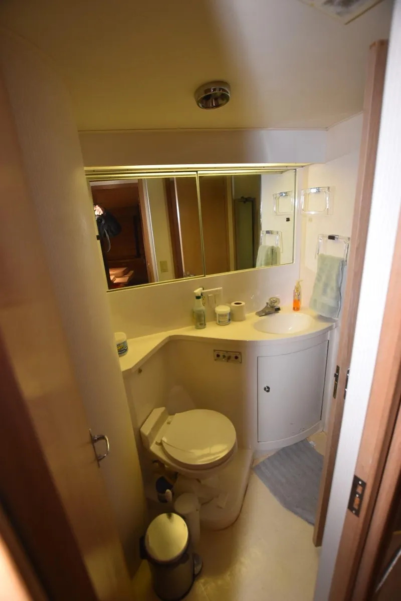 Slide: The Image of Bathroom interior of 1996 Hatteras 50 Convertible yacht, featuring shower and toilet. - 27