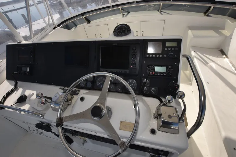 Slide: The Image of 1996 Hatteras 50 Convertible yacht cockpit with covered seating and storage compartments. - 29