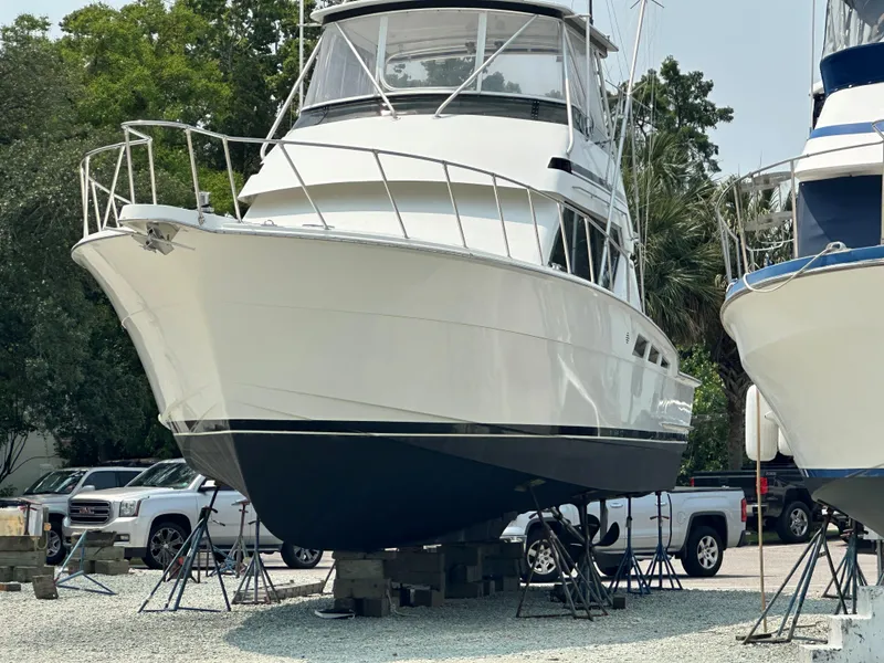 Slide: The Image of 1996 Hatteras 50 Convertible yacht on dry dock, showcasing sleek design and sturdy build. - 3