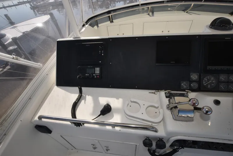 Slide: The Image of 1996 Hatteras 50 Convertible yacht helm with steering wheel and navigation controls. - 30