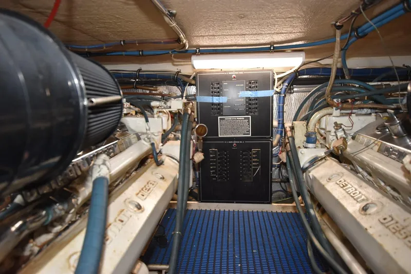 Slide: The Image of Engine room of a 1996 Hatteras 50 Convertible yacht, showcasing machinery and equipment. - 37