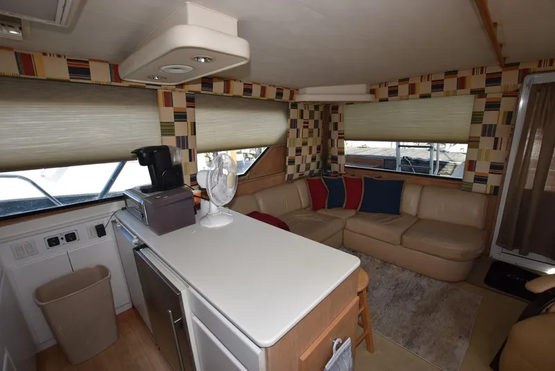 Slide: The Image of 1996 Hatteras 50 Convertible yacht docked, showcasing sleek design and fishing equipment. - 5