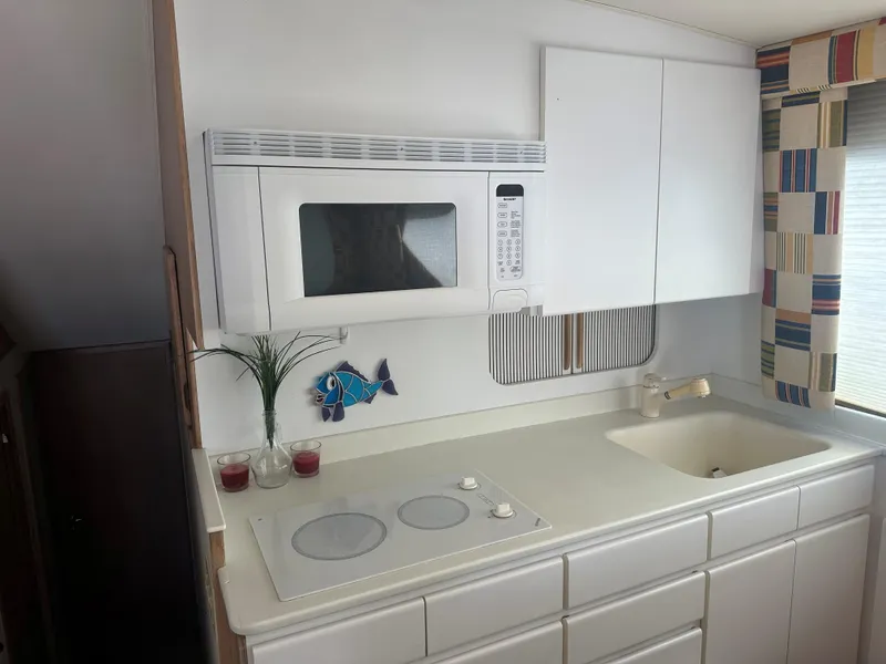 Slide: The Image of Interior of 1996 Hatteras 50 Convertible yacht with modern kitchen amenities. - 8