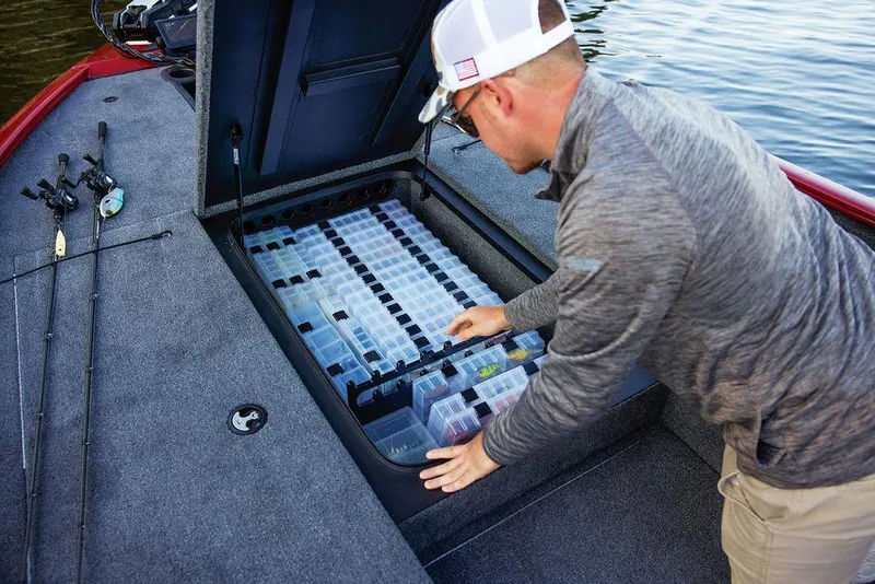 Slide: The Image of Man organizing tackle storage on 2025 Tracker Savage 215 boat. - 34