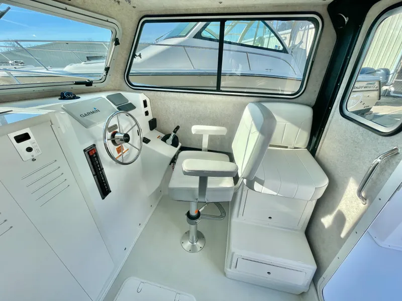 Slide: The Image of 2020 Parker 2520 XLD Sport Cabin interior with steering wheel and seating. - 10