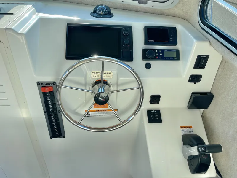Slide: The Image of Control panel of 2020 Parker 2520 XLD Sport Cabin boat with steering wheel and navigation equipment. - 11