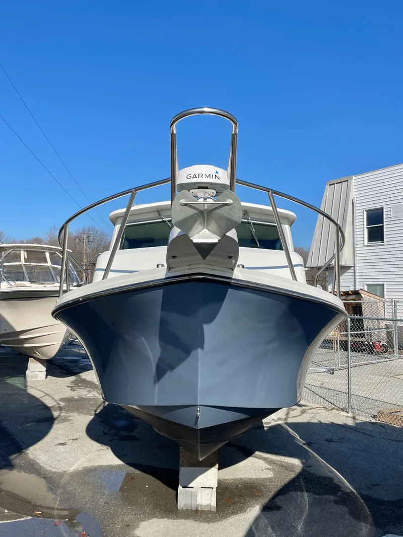 Slide: The Image of 2020 Parker 2520 XLD Sport Cabin boat, front view, docked outdoors. - 14