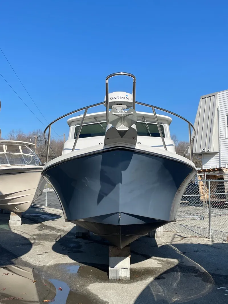 Slide: The Image of 2020 Parker 2520 XLD Sport Cabin boat on display in a marina. - 15