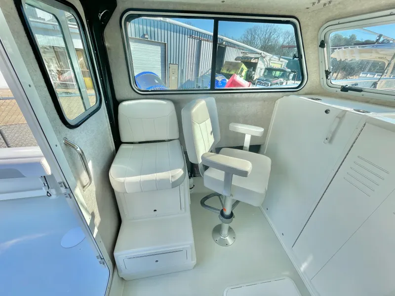 Slide: The Image of Interior of 2020 Parker 2520 XLD Sport Cabin with white seating and windows. - 9