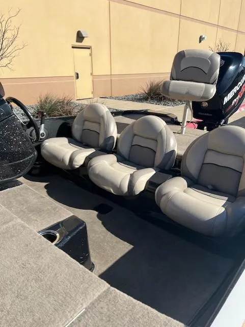 Slide: The Image of 2013 Nitro Z6 boat interior with three cushioned seats and a Mercury engine. - 6