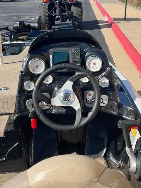 Slide: The Image of Steering console of a 2013 Nitro Z6 boat with gauges and controls. - 7