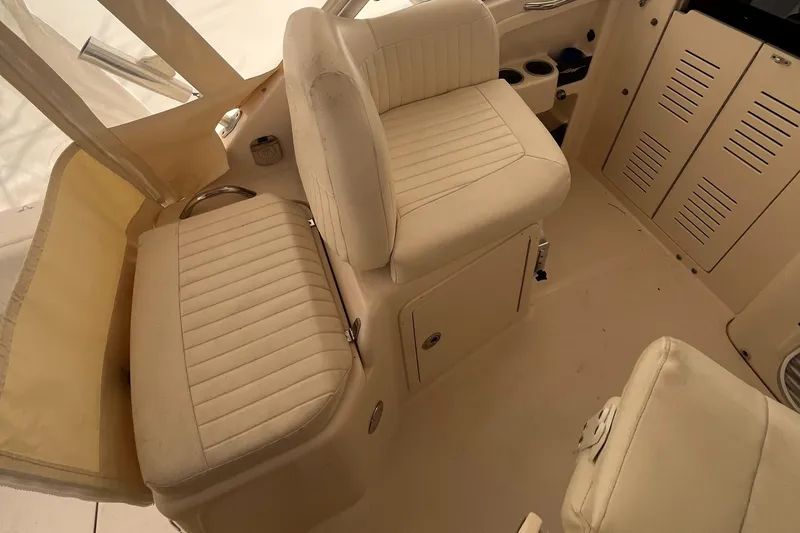 Slide: The Image of 2012 Grady-White Express 305 boat interior with beige seating and storage compartments. - 12