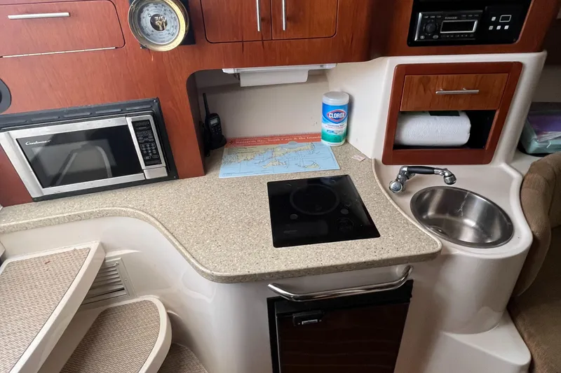 Slide: The Image of Compact kitchen area in a 2012 Grady-White Express 305 boat with microwave and sink. - 15