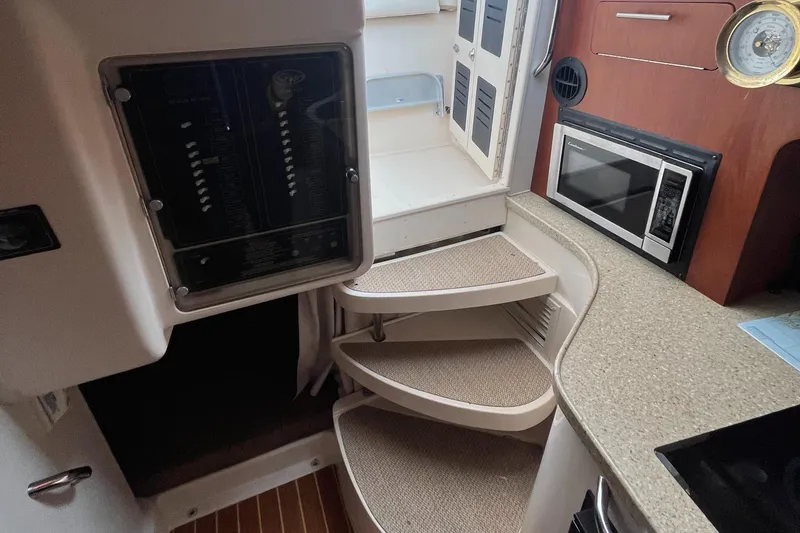 Slide: The Image of Interior of 2012 Grady-White Express 305 boat with stairs, microwave, and countertop. - 16