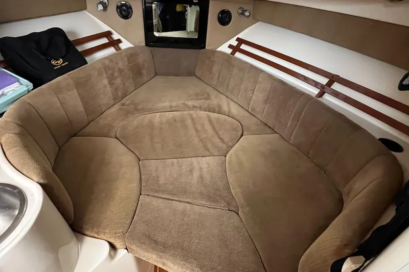Slide: The Image of 2012 Grady-White Express 305 cabin interior with cushioned seating and wood accents. - 18