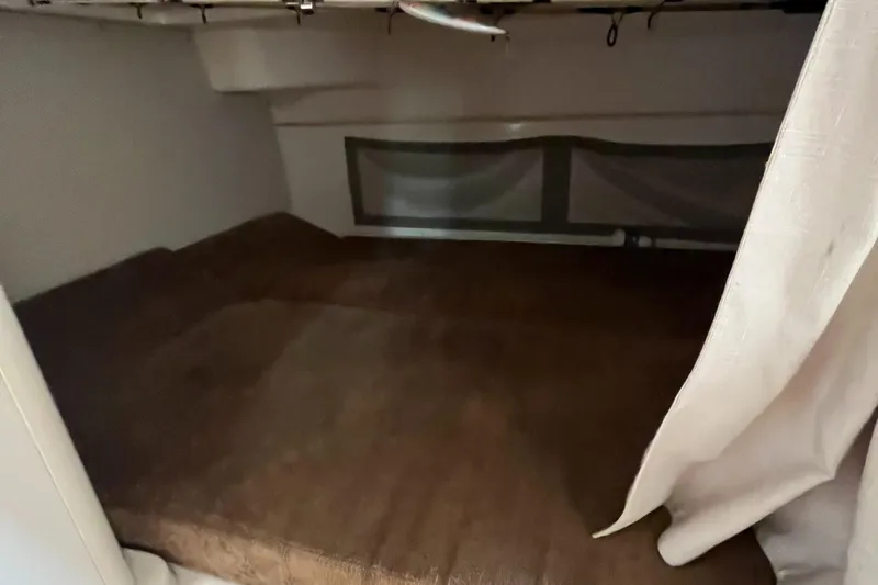 Slide: The Image of 2012 Grady-White Express 305 cabin interior with cozy sleeping area. - 19