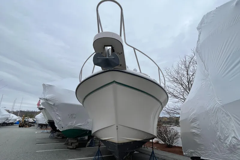 Slide: The Image of 2012 Grady-White Express 305 boat in storage, front view, overcast sky. - 2