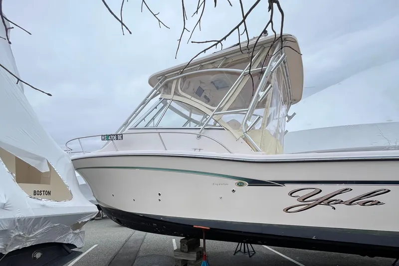 Slide: The Image of 2012 Grady-White Express 305 boat docked, featuring sleek design and enclosed cabin. - 3