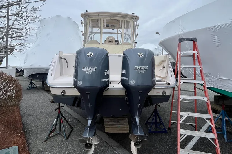 Slide: The Image of 2012 Grady-White Express 305 boat with twin Yamaha 300 engines, docked and covered. - 5