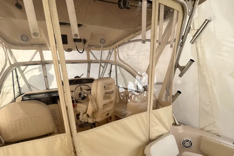 Slide: The Image of Interior view of 2012 Grady-White Express 305 boat with beige seating and helm. - 7