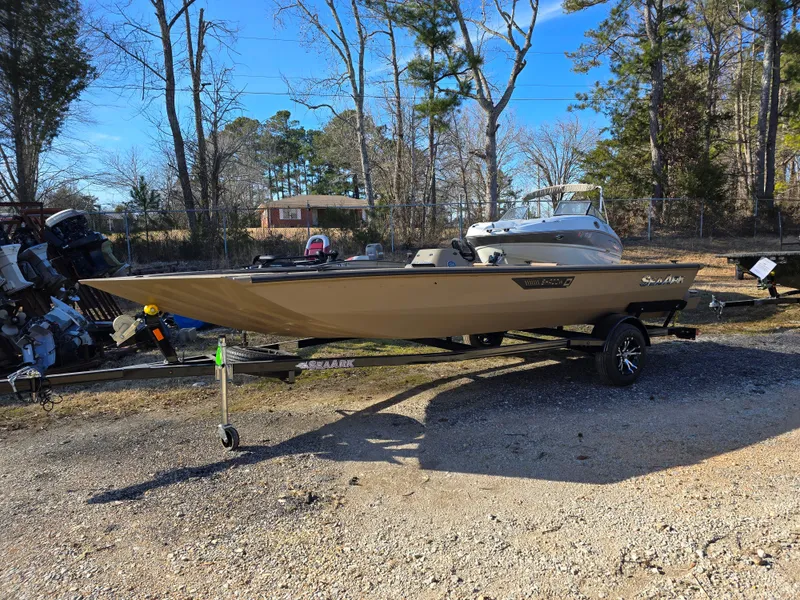 The Image of 2025 SeaArk Shadow 18 boat displayed indoors on a trailer. - 0
