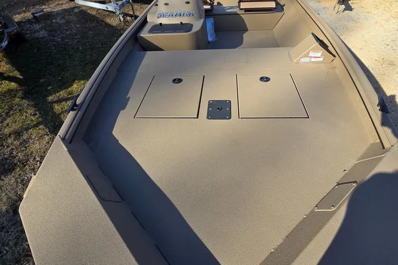 Slide: The Image of 2025 SeaArk Shadow 18 boat with dual platforms and ladder, parked outdoors. - 2