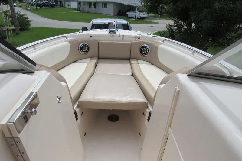 Slide: The Image of 2013 Grady-White Freedom 275 boat interior with beige seating and open deck view. - 22
