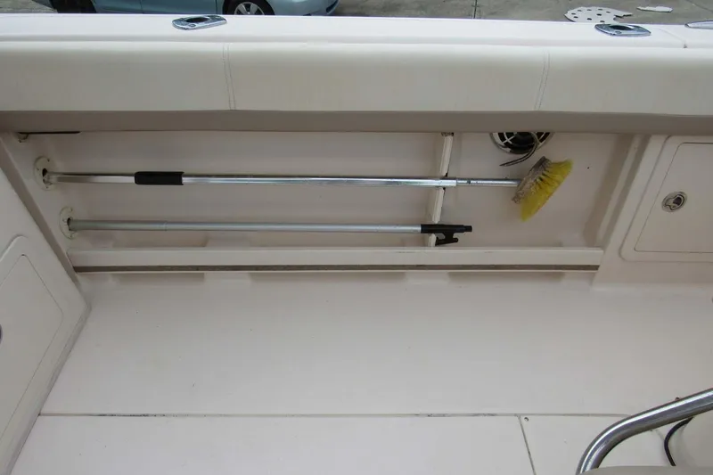 Slide: The Image of Storage compartment on 2013 Grady-White Freedom 275 boat with cleaning tools. - 28