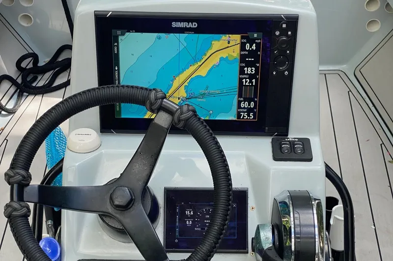 Slide: The Image of 2016 Maverick 18 HPX-V boat dashboard with Simrad navigation display. - 3