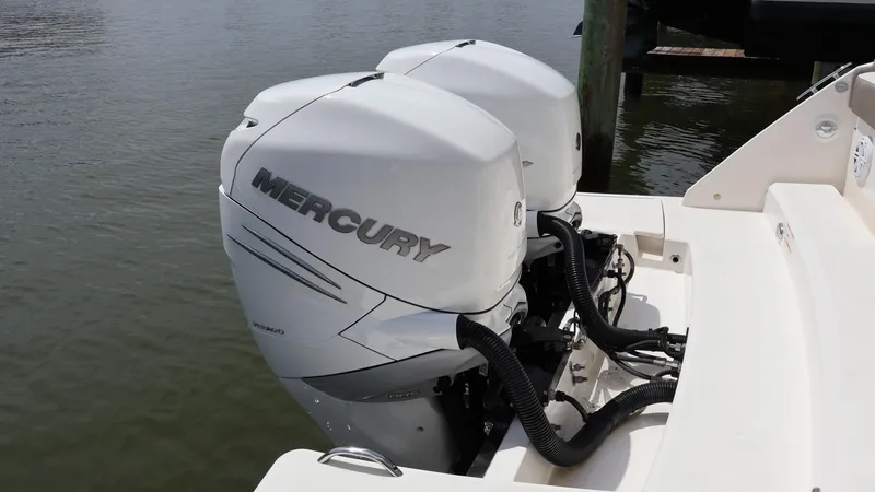 Slide: The Image of 2022 Tiara Yachts 34 LX with dual Mercury outboard engines, docked on calm water. - 10