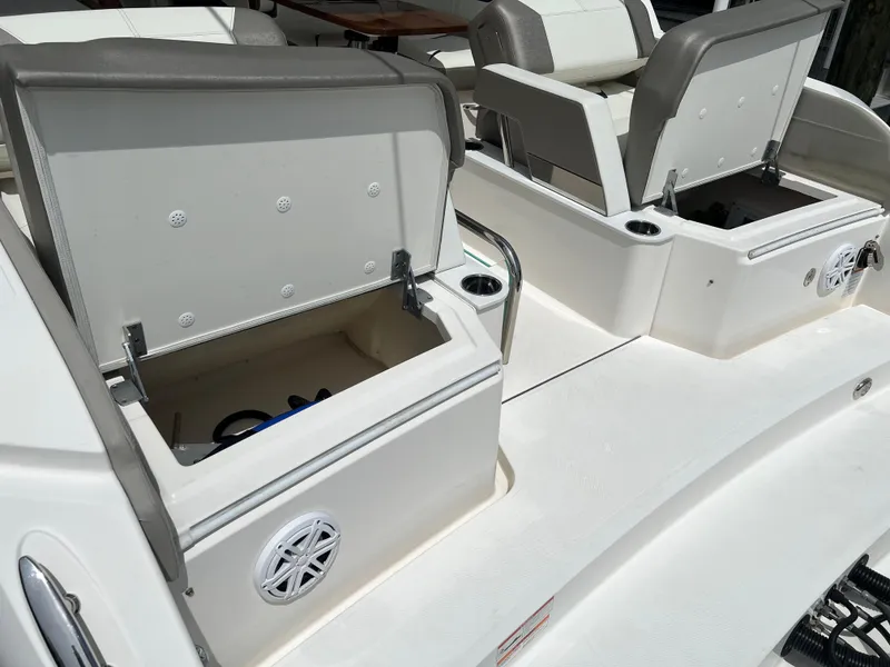 Slide: The Image of 2022 Tiara Yachts 34 LX boat interior with open storage compartments and seating. - 12