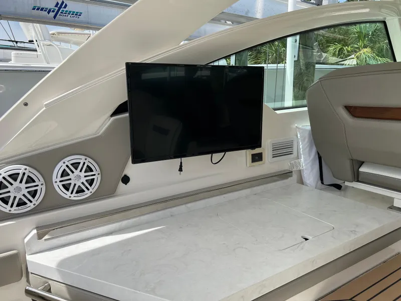 Slide: The Image of 2022 Tiara Yachts 34 LX interior with TV and seating area. - 25