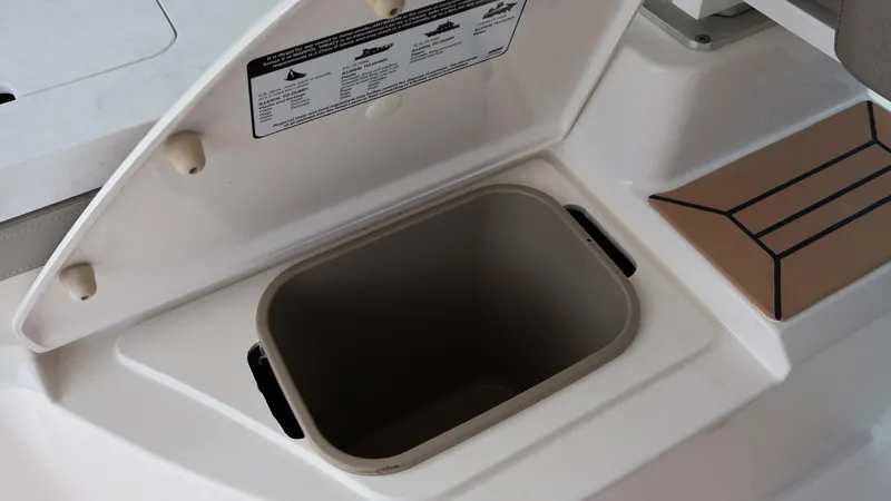 Slide: The Image of 2022 Tiara Yachts 34 LX storage compartment with open lid, showcasing interior space. - 29