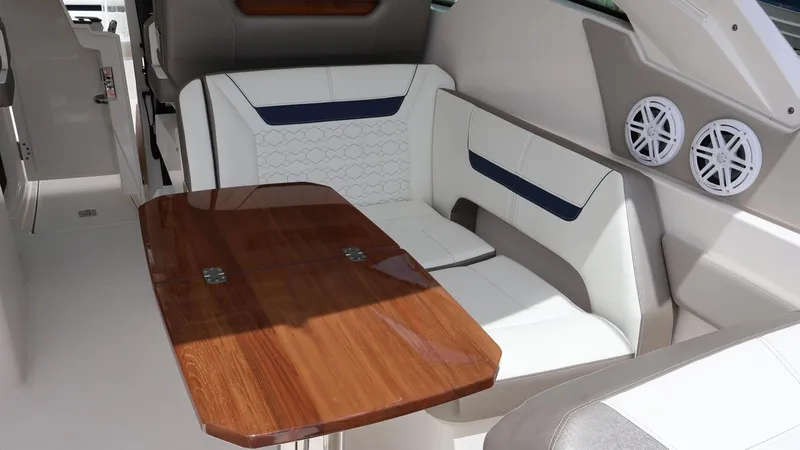 Slide: The Image of Interior of 2022 Tiara Yachts 34 LX, featuring elegant seating and wooden table. - 30