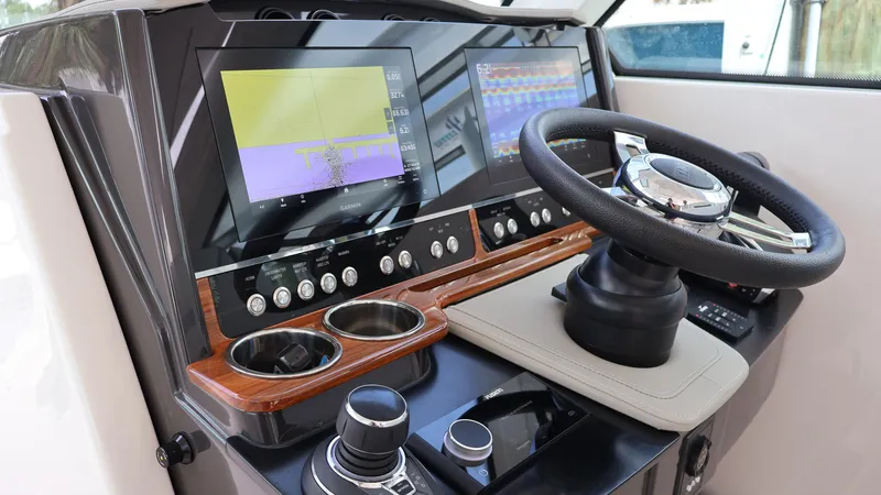 Slide: The Image of 2022 Tiara Yachts 34 LX helm with dual displays and modern controls. - 33